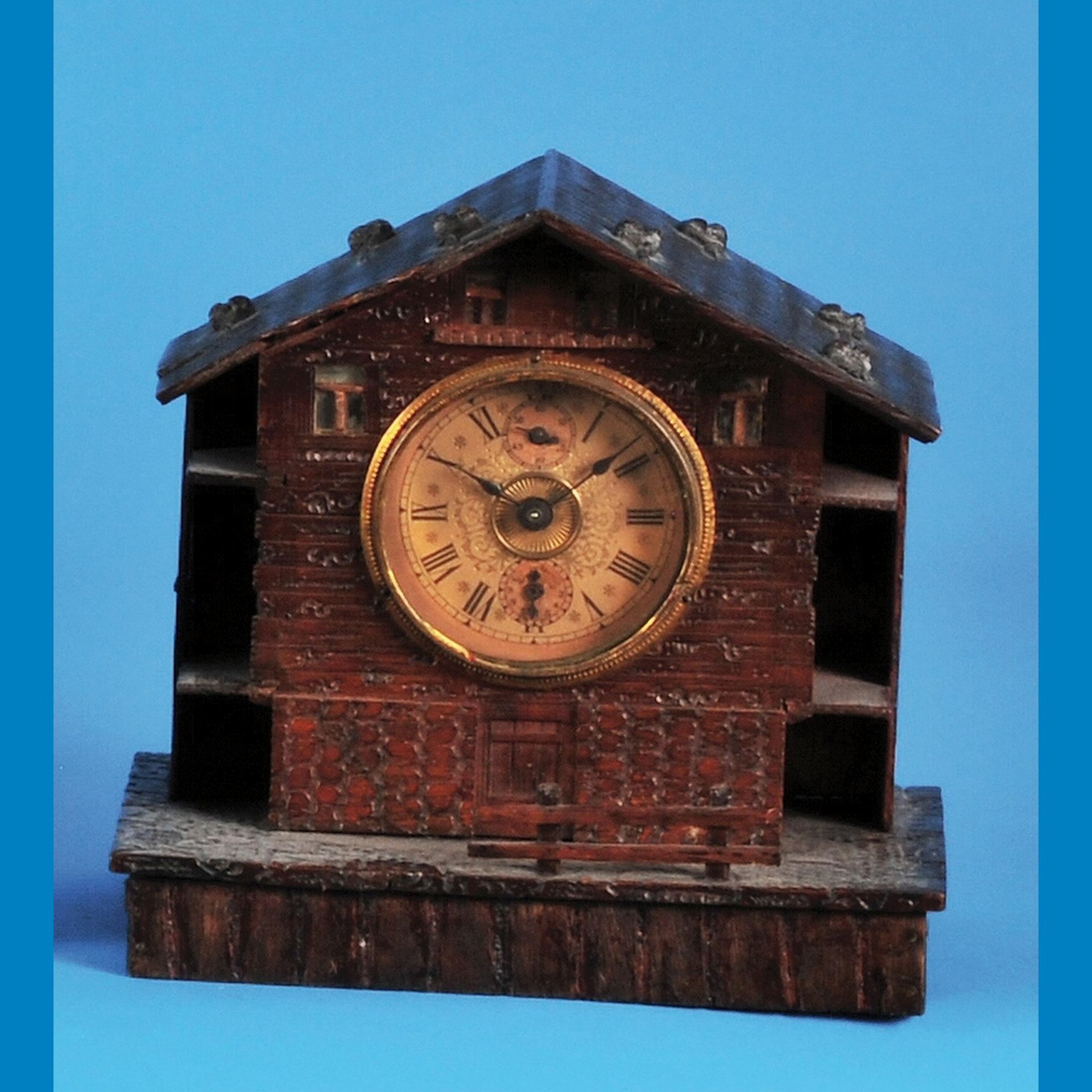 Small wooden table clock with musical mechanism as alarm clock