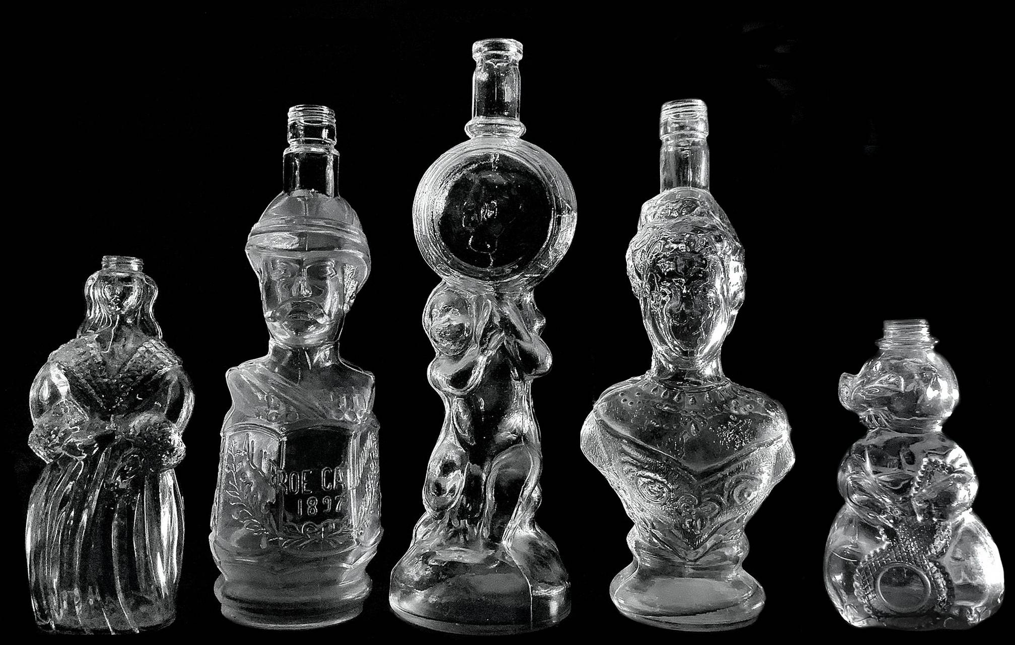 Group of 5 glass bottles and crystal, 20th century. Various sizes and shapes. adapted plugs.