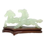 Pair of horses in light green jade with a wooden base, China, 20th century. H cm x 10 cm 17x6