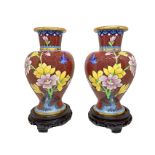 Pair of metal vases with floral decoration, 20th century. With wooden base. H 24 cm