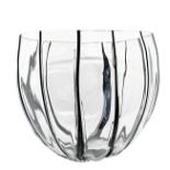 Centerpiece of rounded irregular shape with thin bands applied in paste black glassy,
