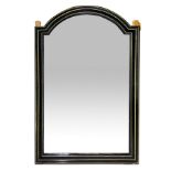 Mirror in black lacquered wood and bordered gilded brass rectangular in shape with the upper side ar