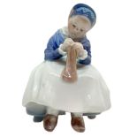 Copenhagen porcelain figurine depicting child stitching. H 14 cm