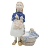 Copenhagen porcelain figurine depicting a child with a doll that takes a bath. H 15 cm