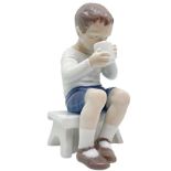 Copenhagen porcelain figurine depicting child with cup. H 14 cm