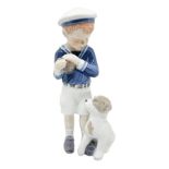 Copenhagen porcelain figurine depicting sailor boy and puppy. H 17 cm