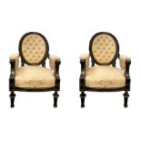 Pair of armchairs in black ebonized wood with oval back, borders Golden brass upholstery in quilted