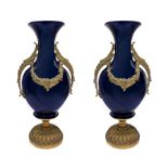 Pair of white porcelain vases with gilded bronze applications, early twentieth century. H 44 cm