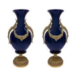 Pair of white porcelain vases with gilded bronze elements applied, early twentieth century. H 44 cm