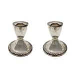 Pair of candlesticks in-weighted sterling. H 8 cm, diameter 7.8 cm