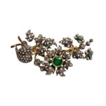 Brooch with flowers and leaves in gold and silver with 1 central root emerald and 2 on the side side