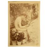 Gaetano D'Agata (1883-1949), printing on paper albuminata depicting nude boy sitting with flowers in