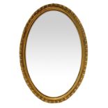 Small oval mirror with wooden frame. Cm 51x35