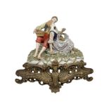 Porcelain statue depicting lovers, with golden metal base, 20th century. 20th century, signed by the