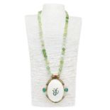 Necklace in non-polished aventurine. Central pendant in shell surrounded by golden metal and enamels