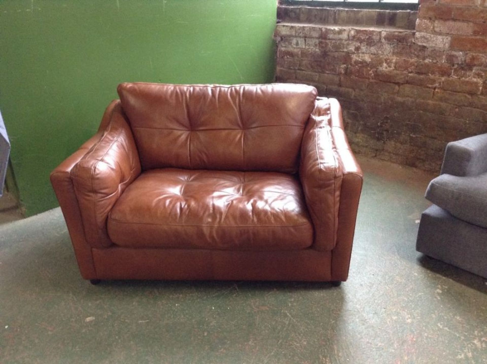 BROWN LEATHER SNUG CHAIR (SCUFFED ON BACK CORNERS