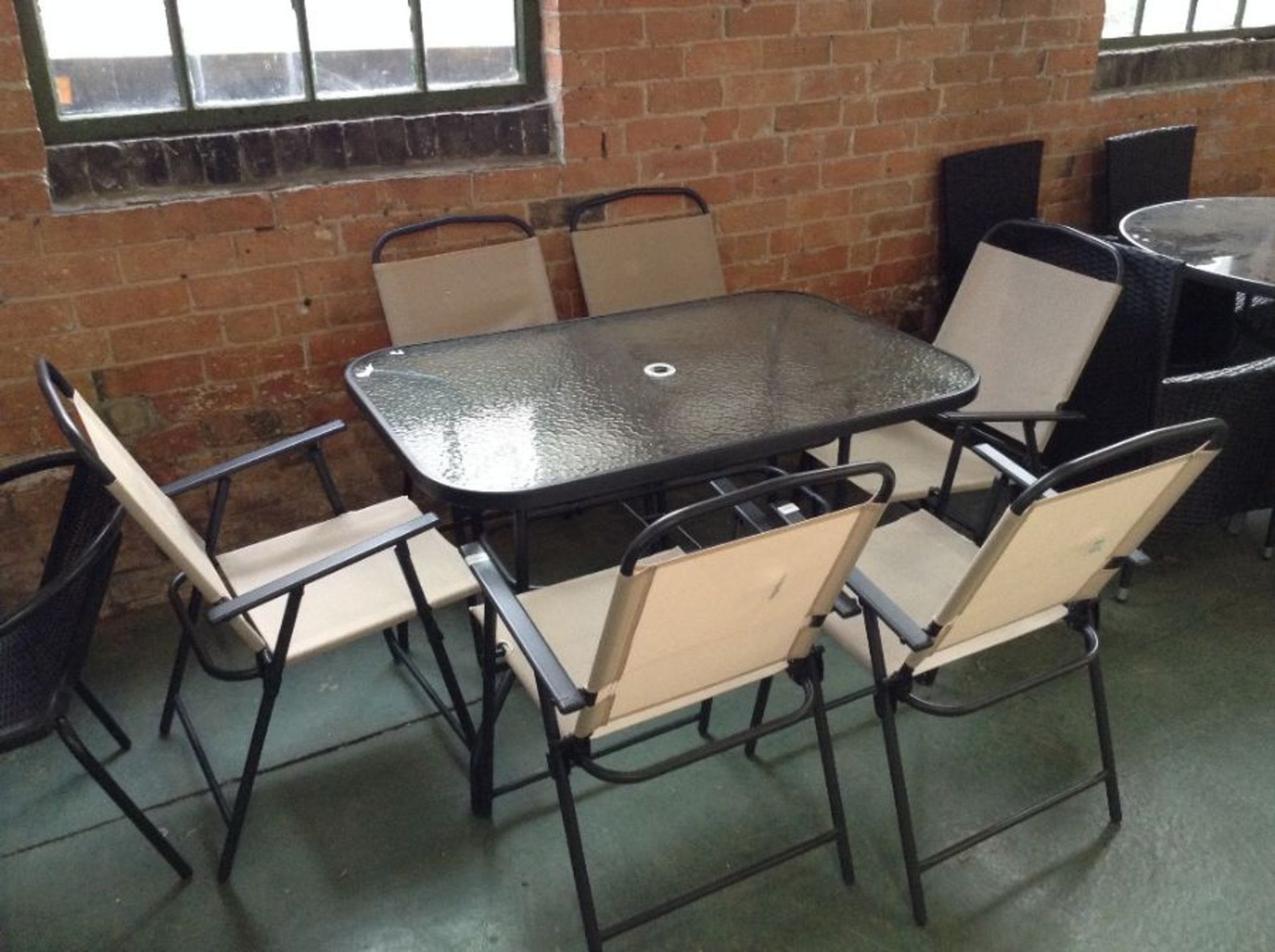 GLASS TABLE AND 6 FOLDING CHAIRS