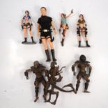 Three Laura Croft figures and three Alien / Predator figures.
