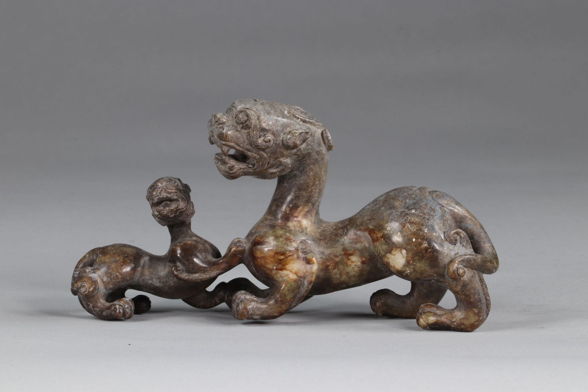 China chimera, in gray-green jade, representing a lioness with her cub, finely executed archaic work