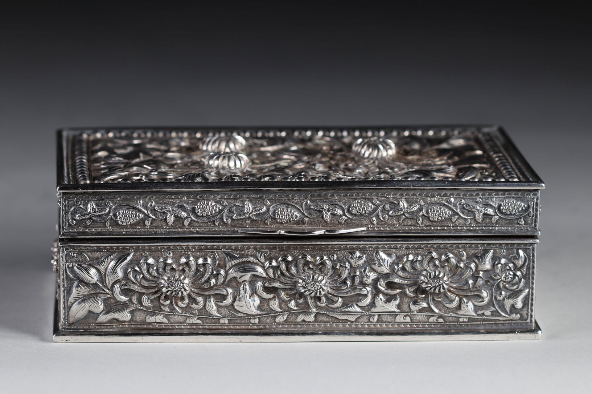 silver box with high relief floral decoration, 19th century China.