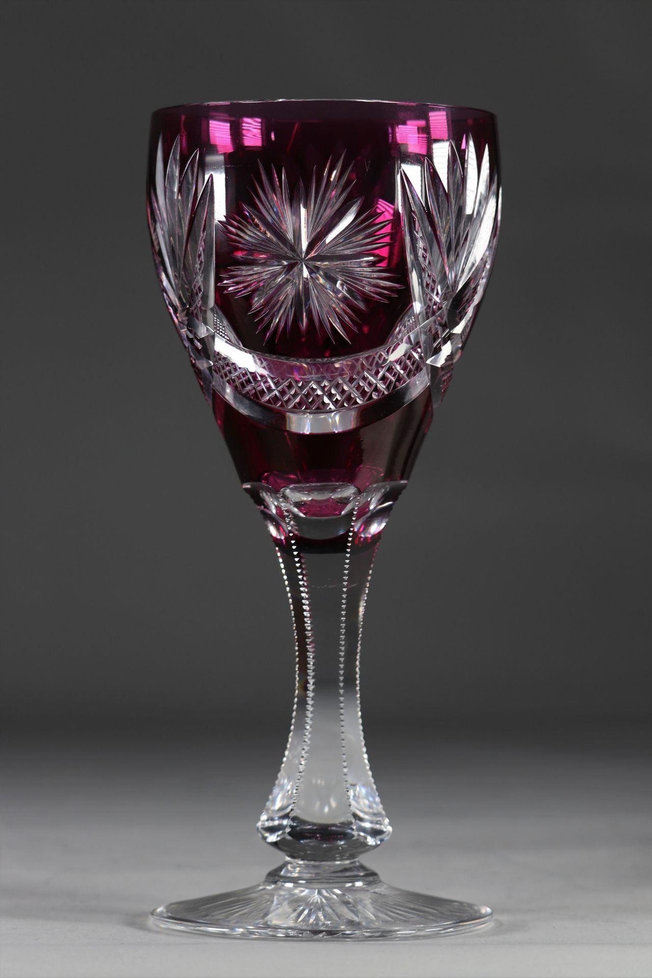 Val Saint Lambert large glass on a finely cut stem on a mauve background