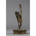 Bronze candlestick surmounted by a character probably from the early years