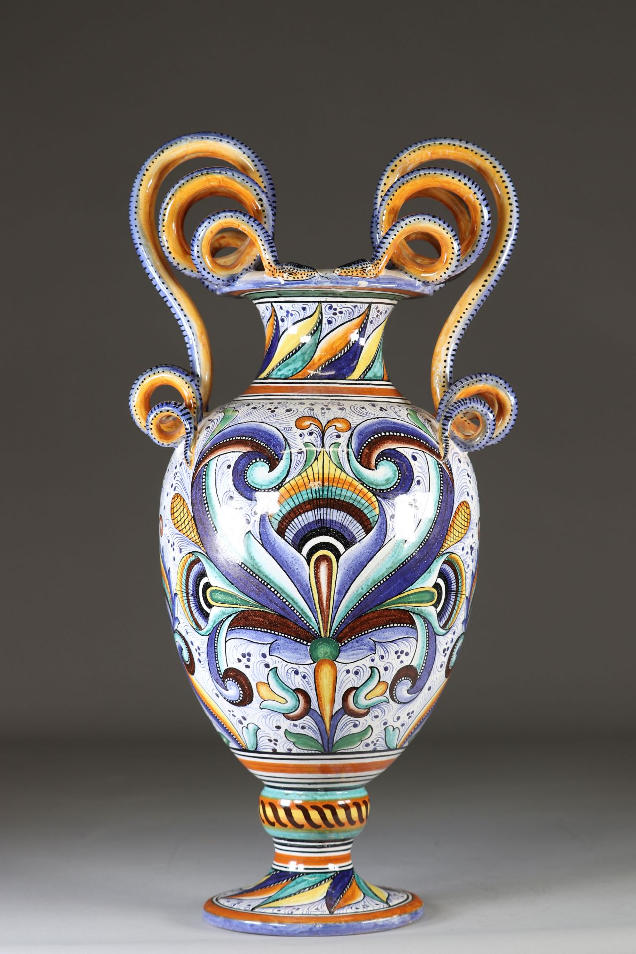 Large vase on pedestal with handles formed of majolica-style earthenware snakes