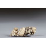 Netsuke carved - a monkey pulling a bag and a teddy bear. Japan Meiji period around 1900