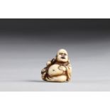 Netsuke carved - a Buddha and a child pulling his ear. Japan Meiji 19th century