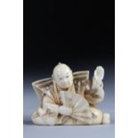 Netsuke carved - a character - a fan. Japan Meiji period around 1900