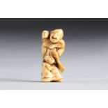 Netsuke carved - a character and children. Japan Edo period