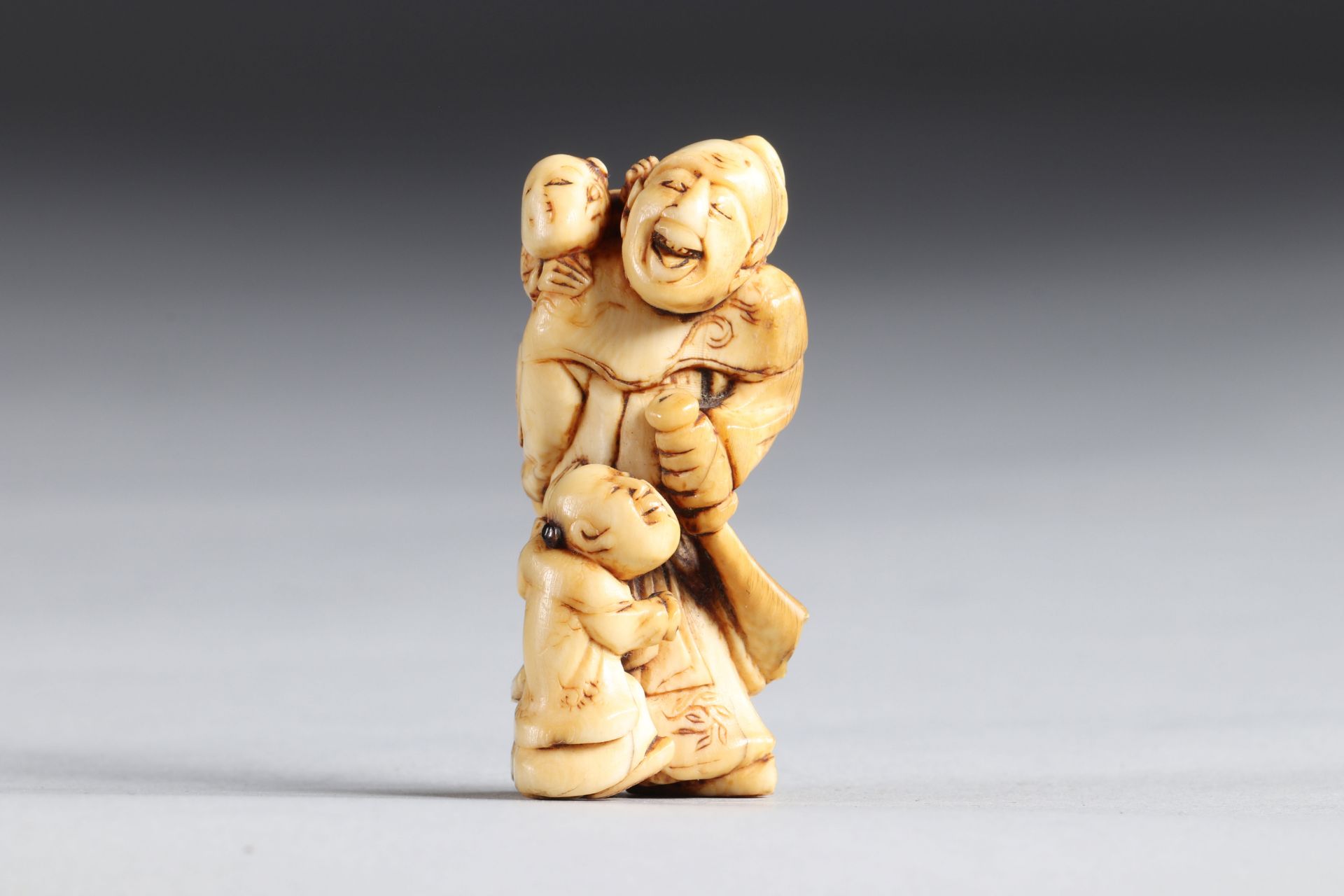 Netsuke carved - a character and children. Japan Edo period