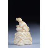 Netsuke carved - a dog on a rock. Japan Edo / Meiji period