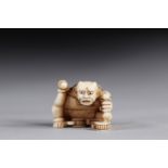 Netsuke / Okimono carved - a seated demon. Japan early 20th century