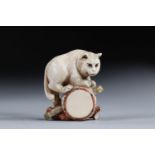 Netsuke carved - a cat on a drum. Japan early 20th century