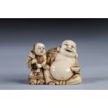 Netsuke carved - Buddha and a child. Japan Meiji period circa 1900 signature