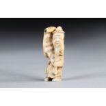 Netsuke carved - a sage carrying a sheet music. Japan Meiji period around 1900