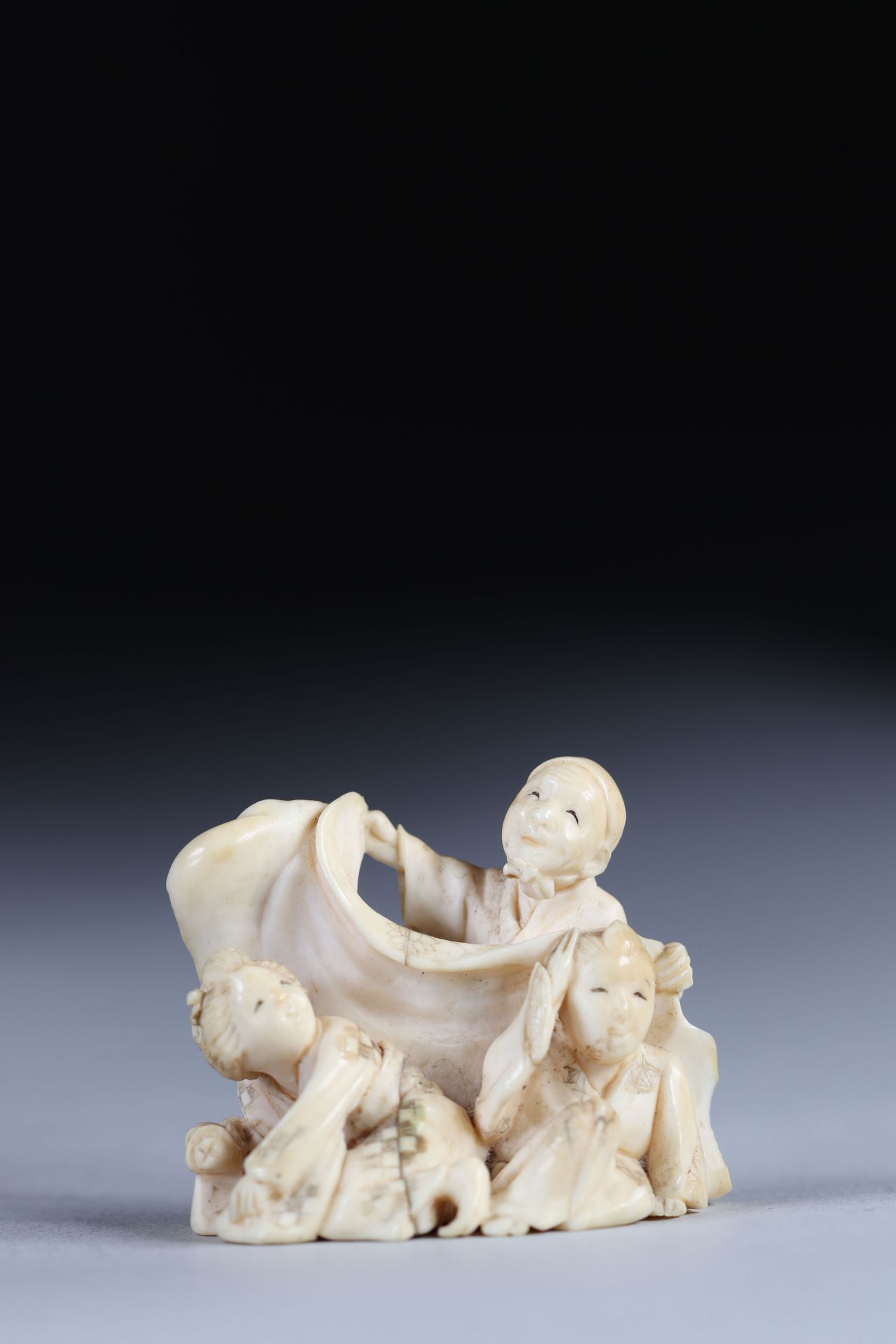 Netsuke carved from a group - figures. Japan Meiji period around 1900