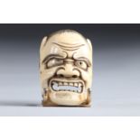 Netsuke / Okimono carved - a mask. Japan MEiji 19th period