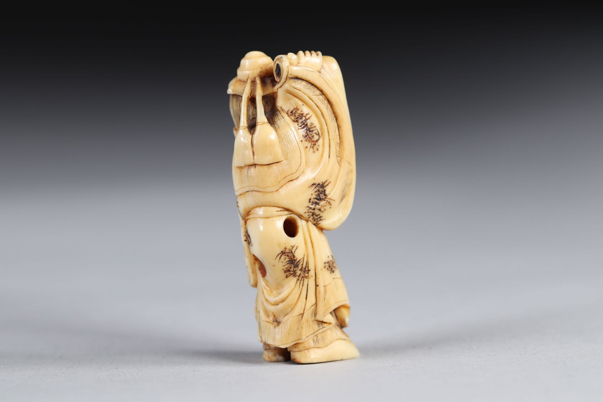 Netsuke carved - a sage carrying a sheet music. Japan Meiji period around 1900 - Image 2 of 2