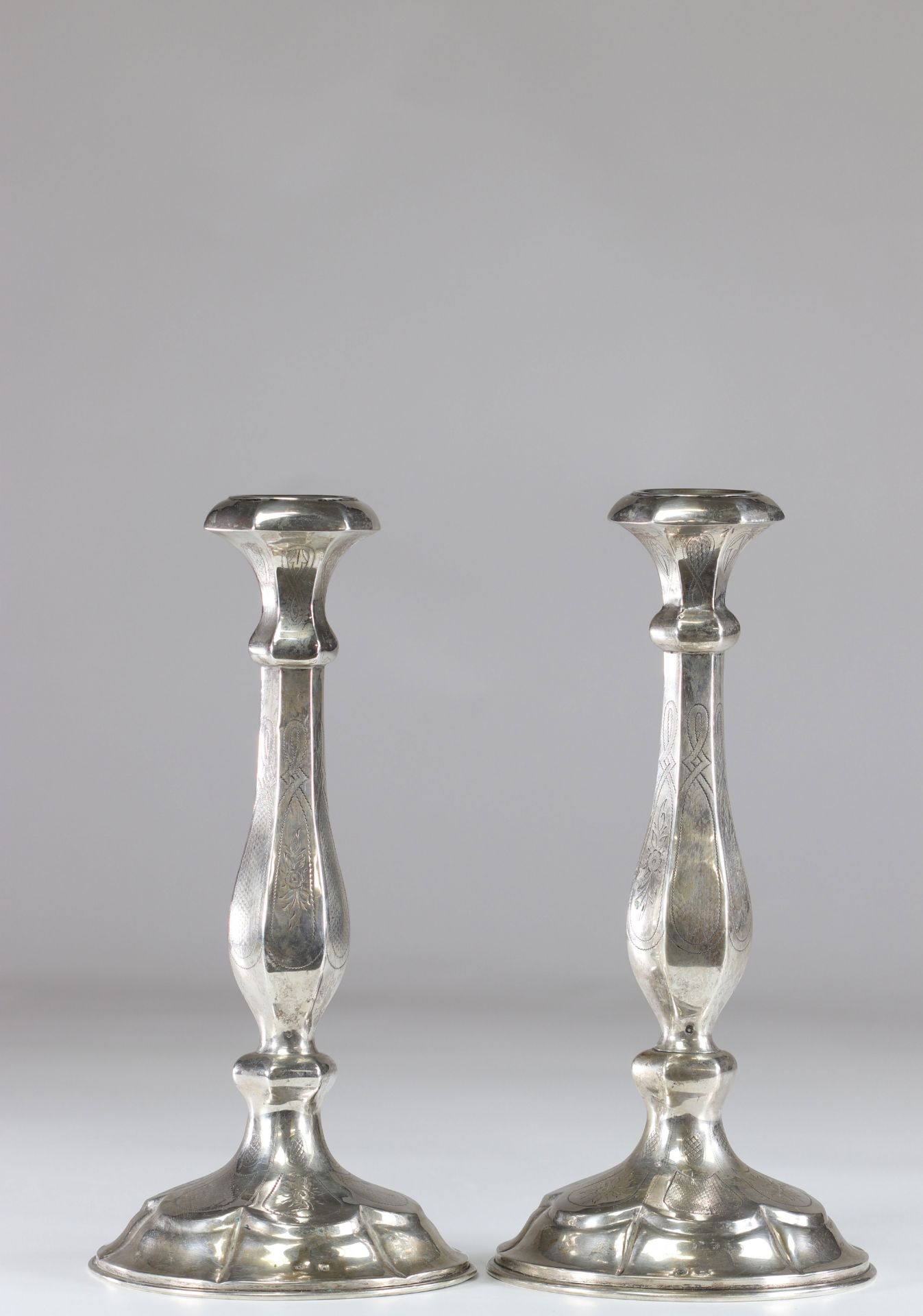 Pair of silver candlesticks with floral decoration