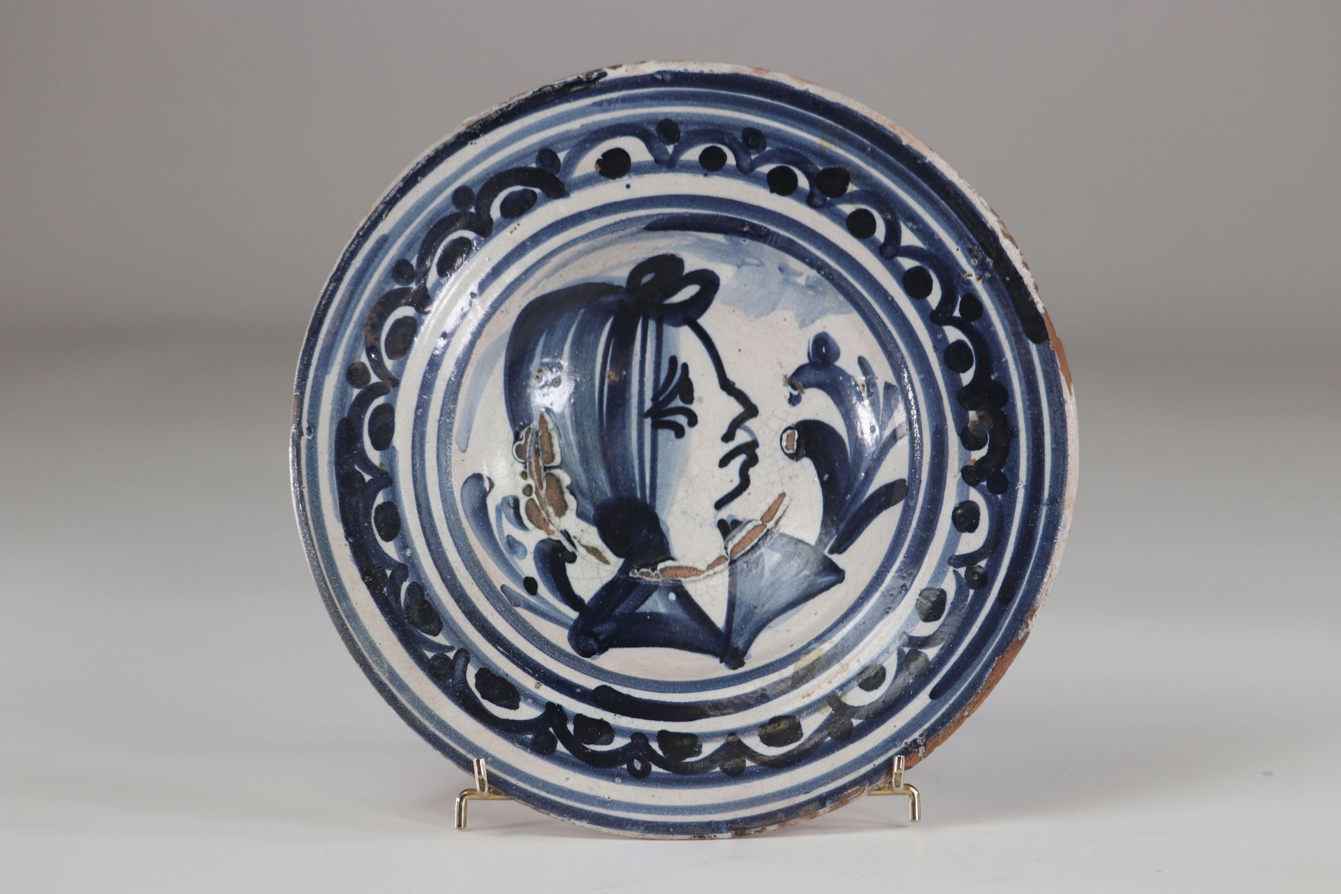 Delft? plate decorated with a woman's head probably 17th