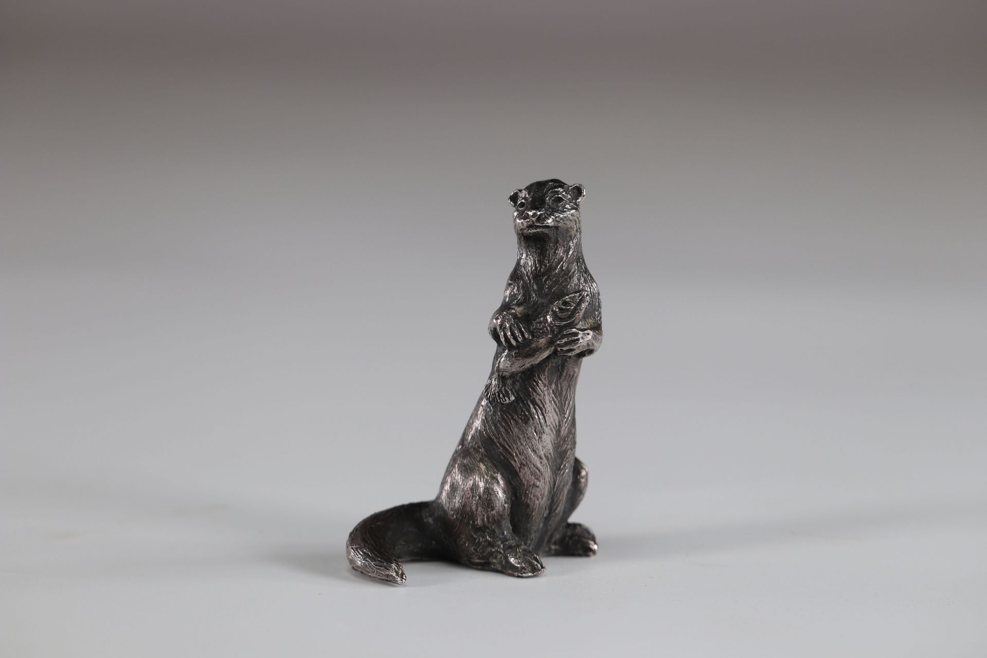 Signature silvered bronze otter to identify