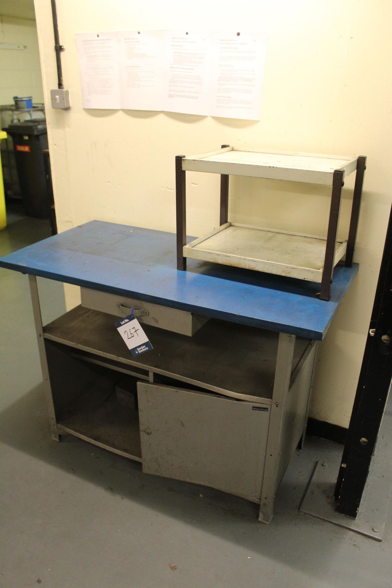 Sterling steel framed workbench with wooden worksurface; under counter drawer; single door