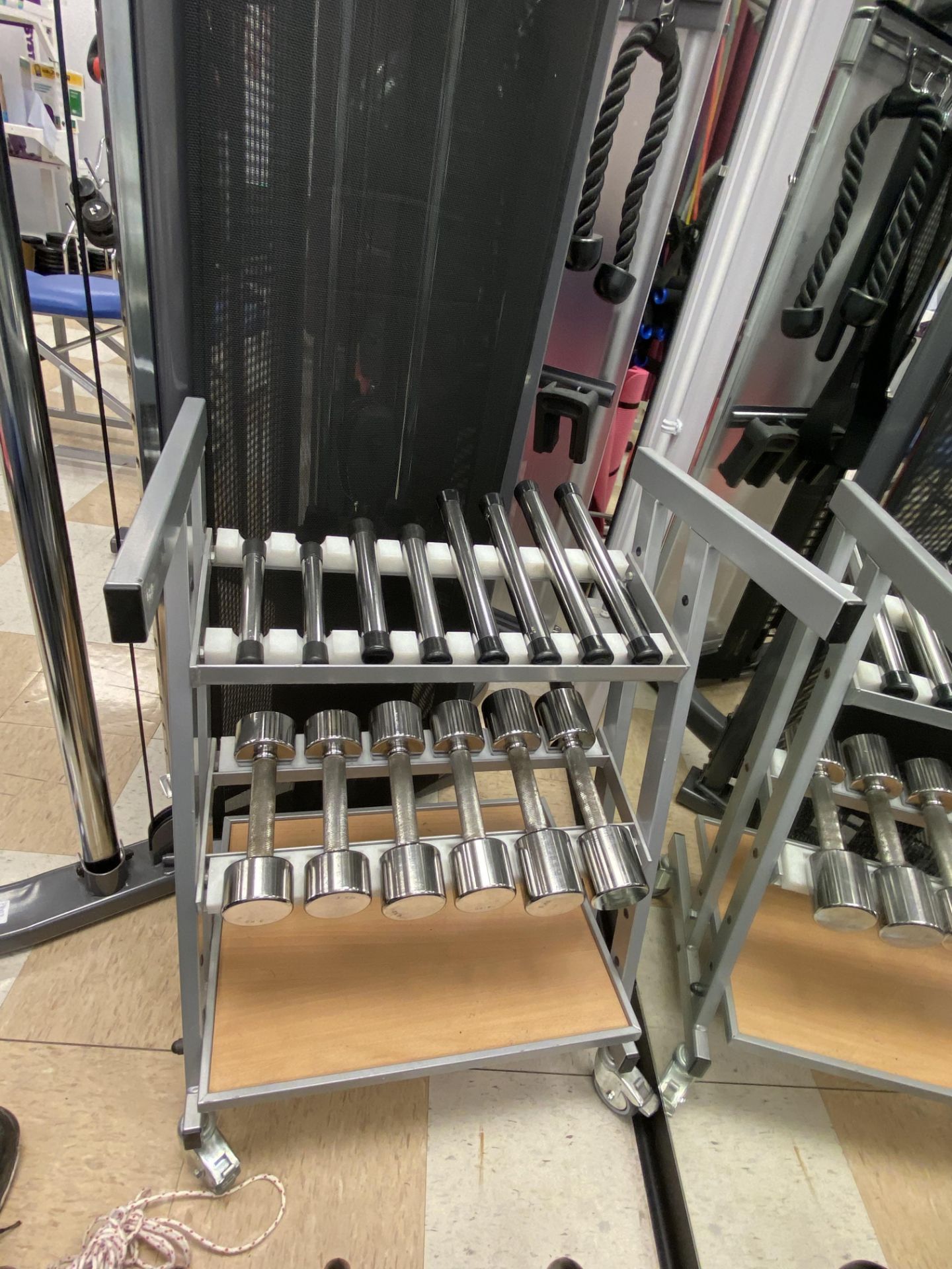 A set of 7 pairs of steel chrome plates dumbbells. 0.5kg-5kg including mobile storage stand