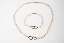 Perlenkette und ArmbandKette L.: 46 cm, mittig verbundenes Herzsymbol in 585er Gelbgold ,