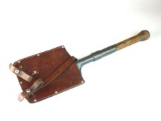 A Swiss WWII entrenching tool with brown leather cover, marked 'Fr. Bangerter Burgen' and dated