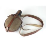 A German Mountain Troops field canteen with brown leather straps and black cup, also used by