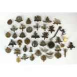 Collection of British cap badges and a Cortebert military watch