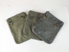 Three German Third Reich Second World War gas cape pouches, comprising two rubberised and one cloth,